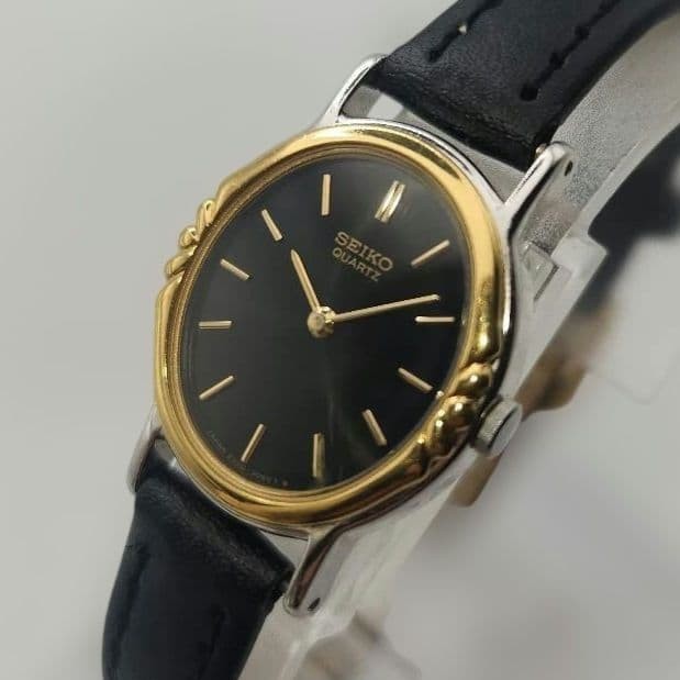 Seiko working ladies’ quartz watch, gold and black oval.