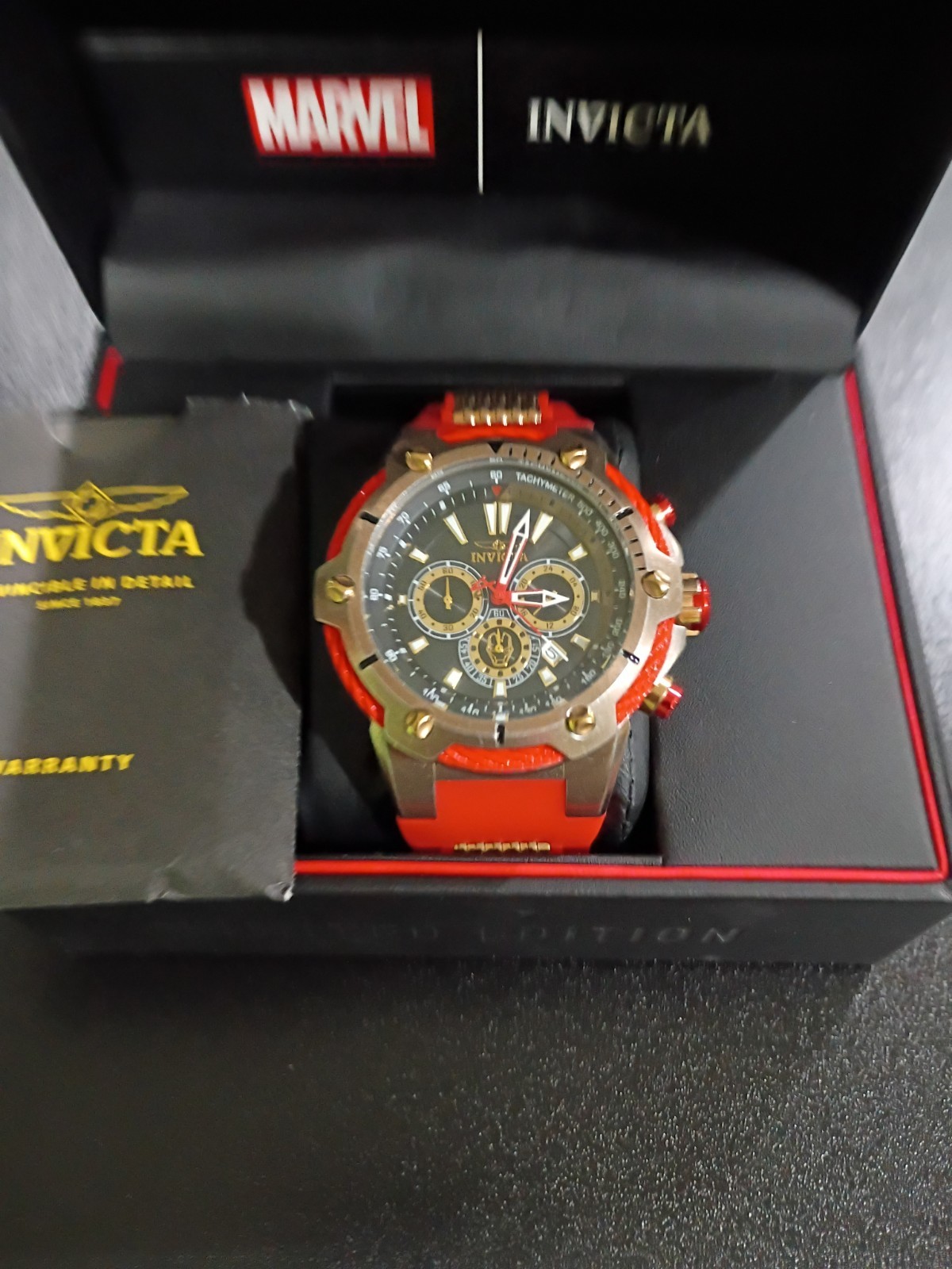 Invicta Marvel Men’s Quartz Chronograph Tachymeter Black/Gold Dial Red Strap Box