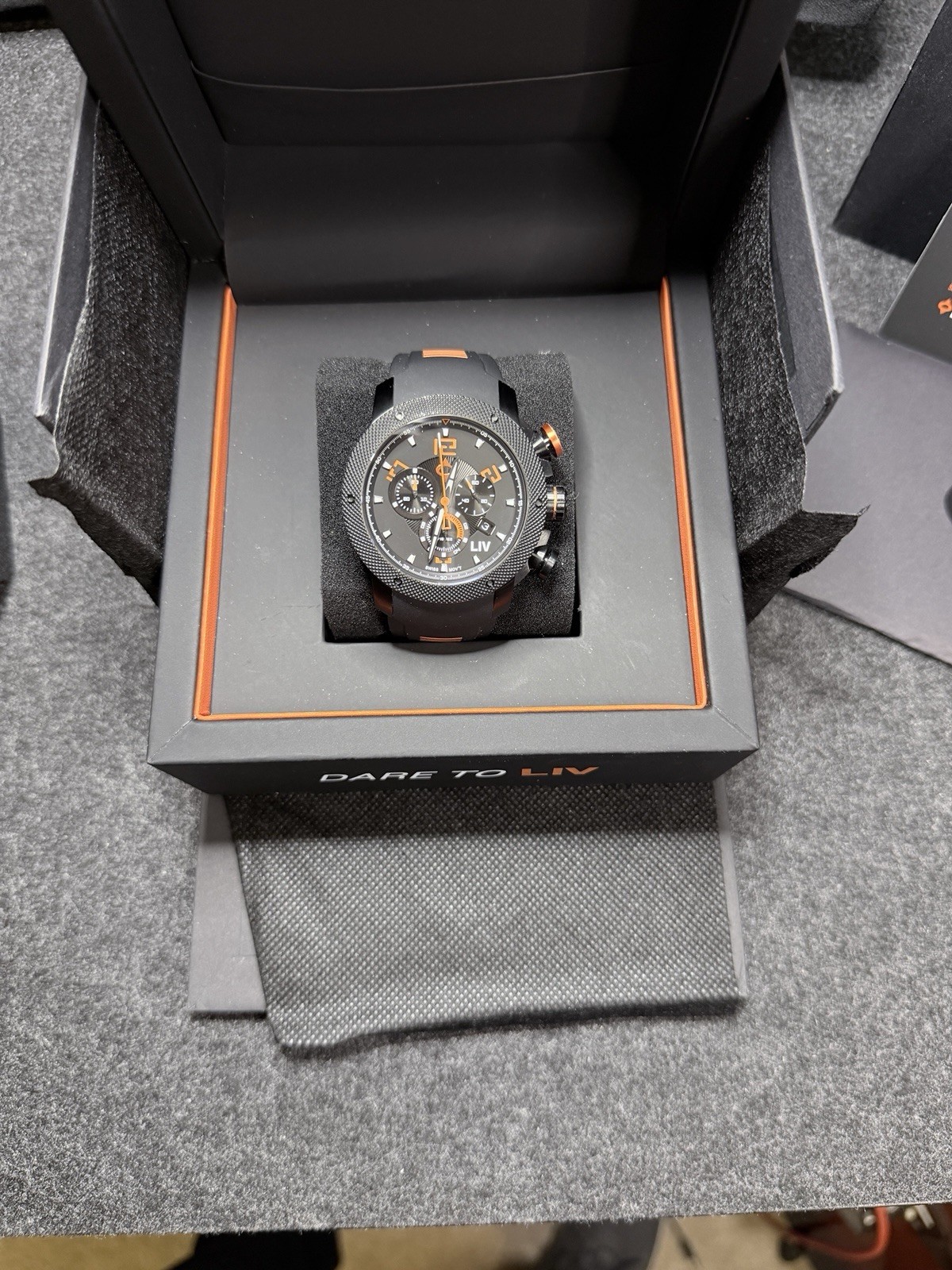 LIV GX1 Signature Orange On A Black Silicone With Orange Accents Strap