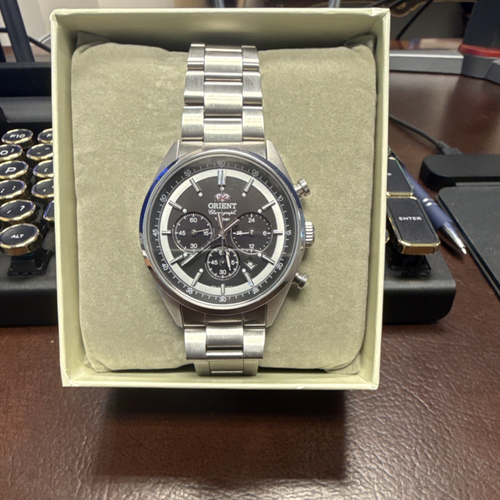 Orient Neo 70’s Solar Panda watch with a dark gray dial and stainless steel band