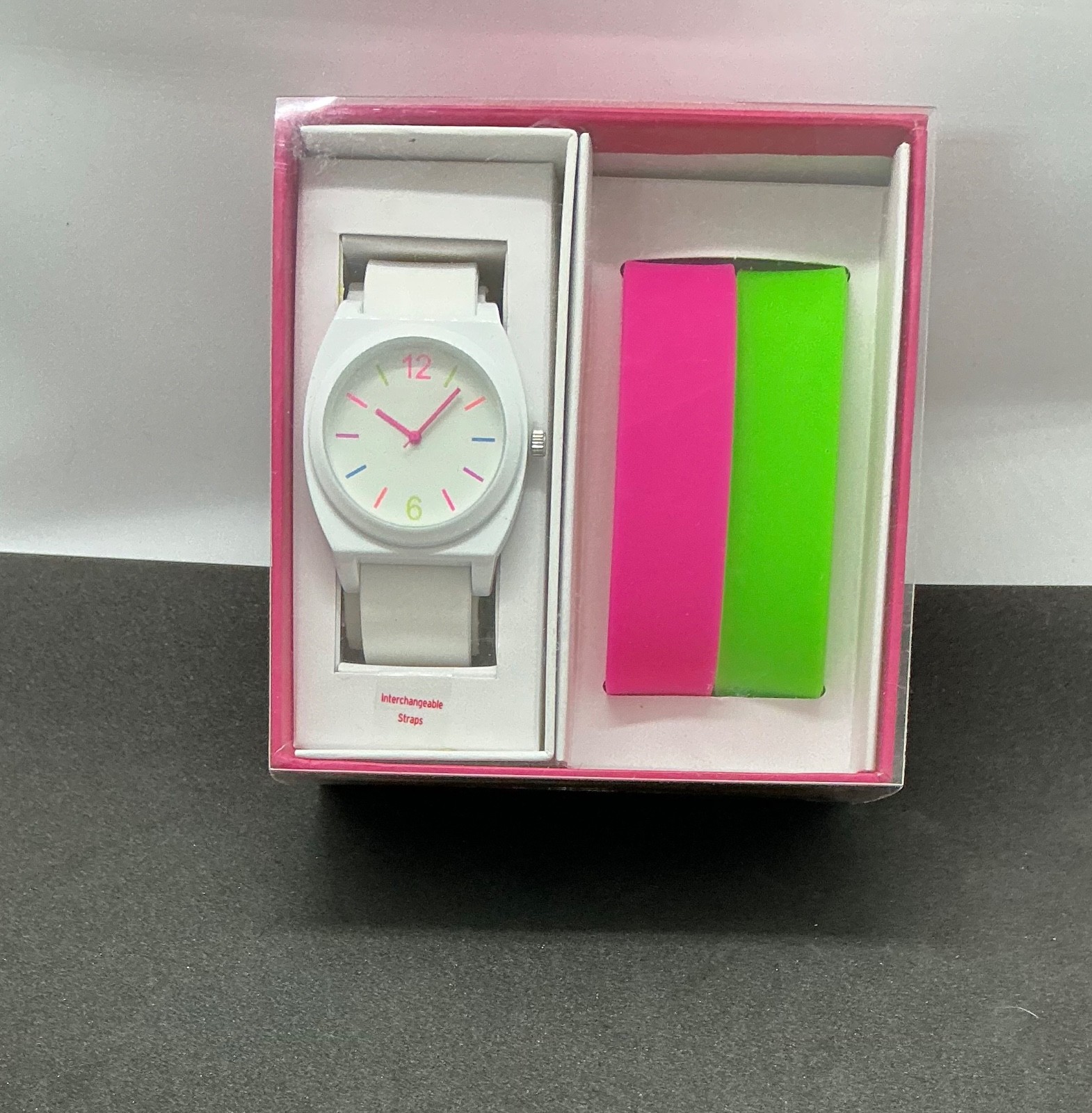 Xhilaration watch with 3 interchangeable straps: white, pink, green. MSRP $19.99