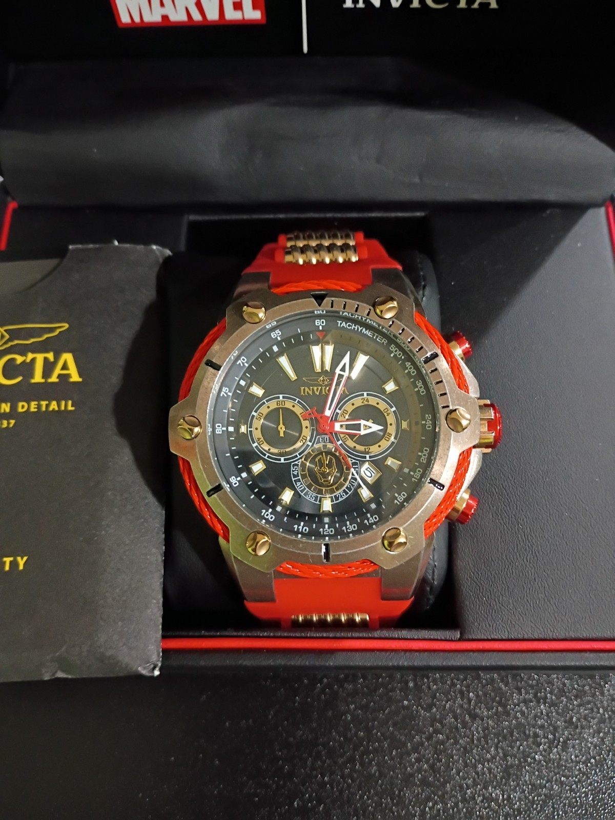 Invicta Marvel Men’s Quartz Chronograph Tachymeter Black/Gold Dial Red Strap Box