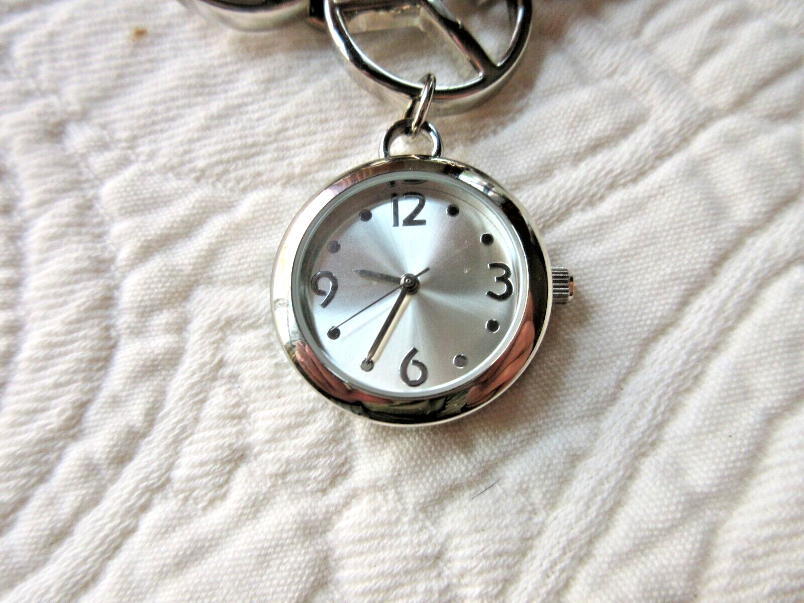 XHILARATION WRISTWATCH POLISHED CHROME PEACE SIGNS SECONDS HAND NEW BATTERY SS
