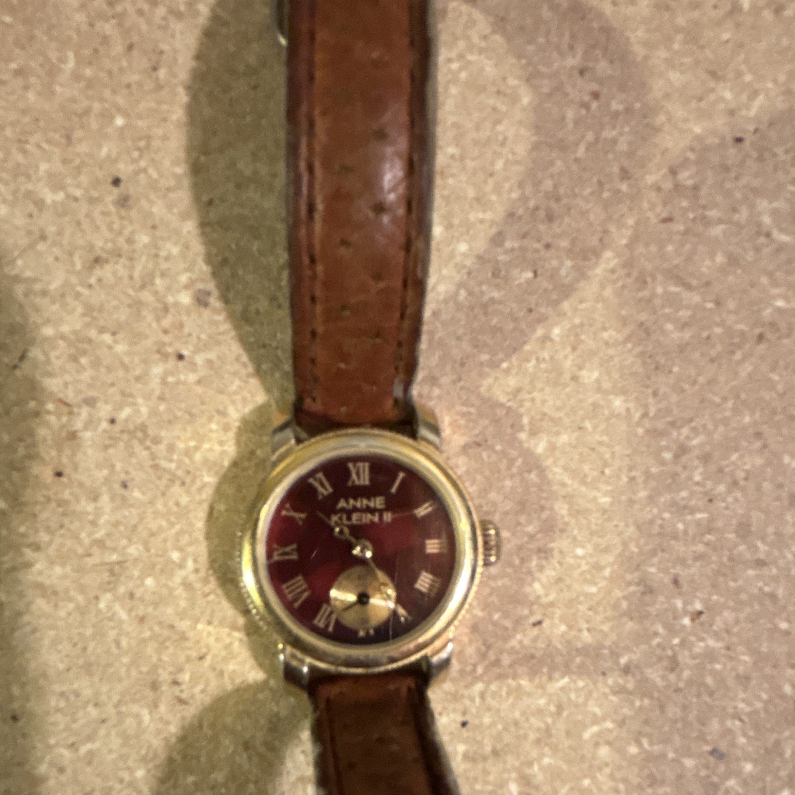 Anne Klein Women’s Quartz Watch Burgundy Roman Dial Gold Case Brown Leather