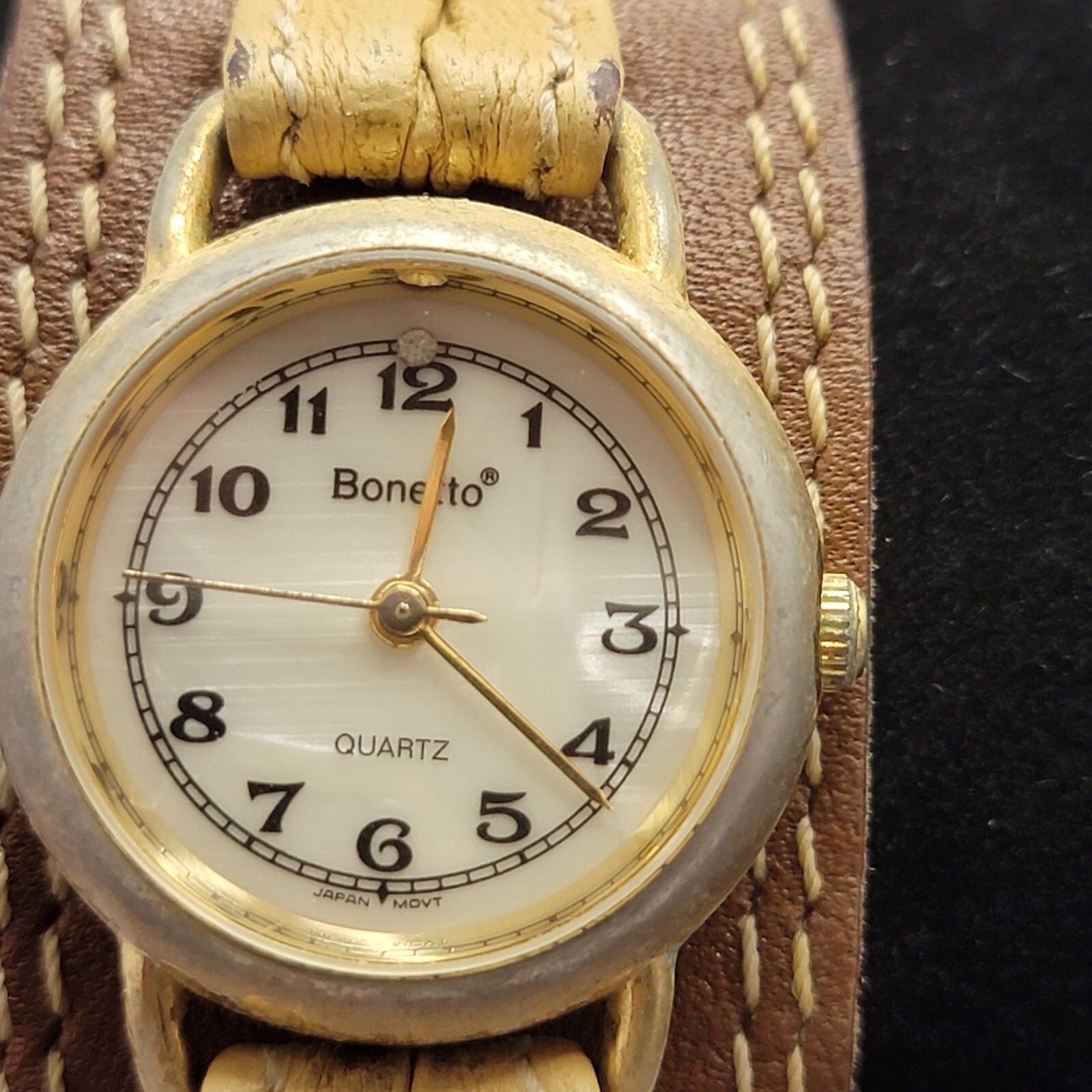 Vintage women’s Bonetto Quartz gold frame watch with leather band