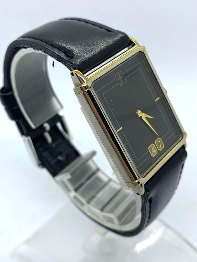 SEIKO rectangular quartz watch with black leather strap.